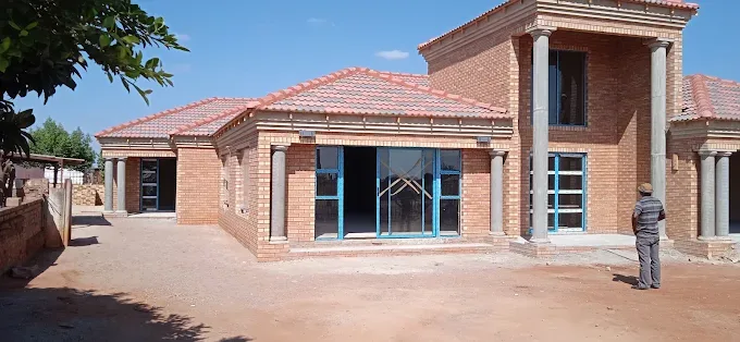 Brick home with custom aluminium doors and windows by J&L