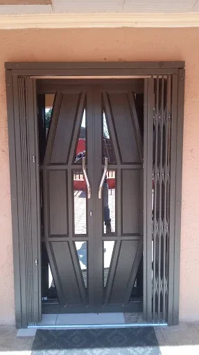 White expanding security gate at a tiled entrance